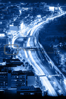 Night road with motion traffic in the city, blue