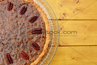Half pecan pie served on a glass plate