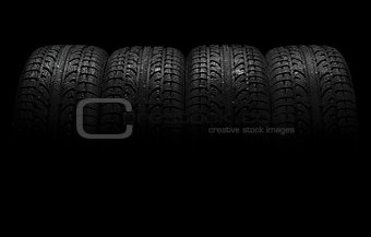 Car tires over black background