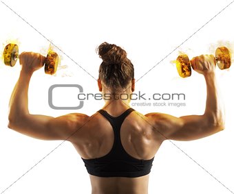 Woman training with  fiery dumbbells