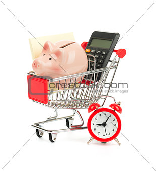 Piggy bank, calculator in shopping cart