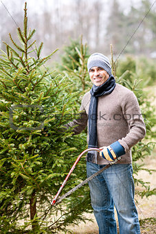 Man cutting Christmas tree