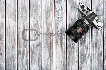 Vintage photo camera on a wooden background