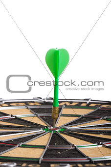 green Dart hitting the middle of dartboard