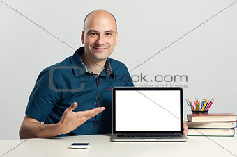 confident young man advertising laptop