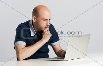 Thoughtful business man working a laptop
