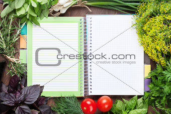 Fresh garden herbs and notepad