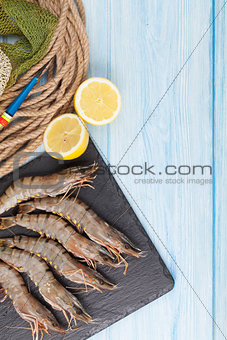 Fresh raw tiger prawns and fishing equipment