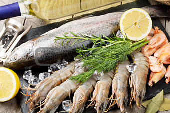 Fresh raw sea food with spices and white wine