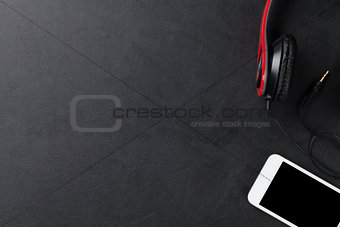 Headphones and smartphone on desk