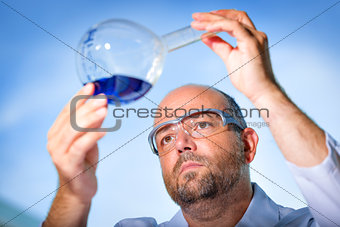 Chemist with blue liquid