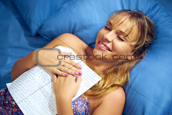Girl In Bed Reading Love Letter From Boyfriend