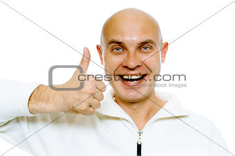 Bald smiling blue-eyed man with thumb up. Studio. isolated