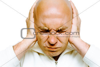 man closed his eyes and covered his ears with his hands. Studio.