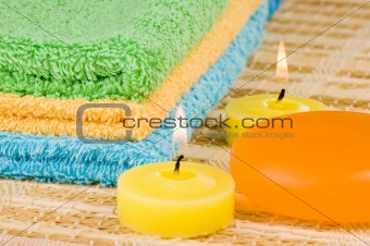 Towels of different colours soap and candles