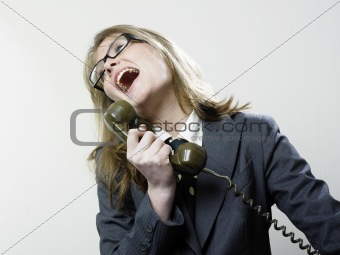 Woman laughing at telephone