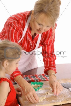 beautiful woman and child baking cookies isolated on white