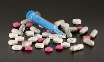 Syringe, tablets and pills