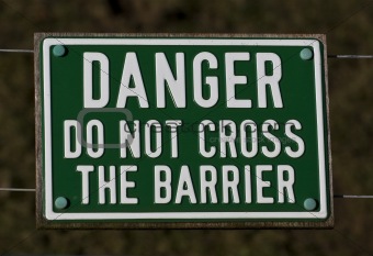 Sign saying do not cross the barrier