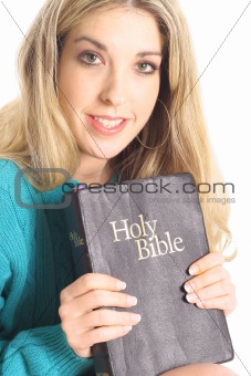shot of a happy woman with a holy bible