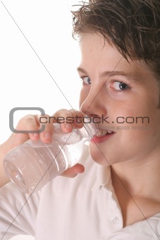 shot of a young boy drinking water vertical upclose