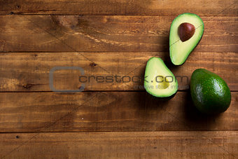 Background fresh avocado on the dark wooden table