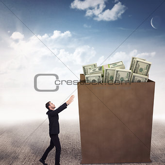 Composite image of businessman with arms raised catching something