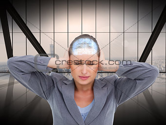 Composite image of close up of annoyed tradeswoman covering her ears