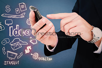 Composite image of businessman in glasses using his tablet pc