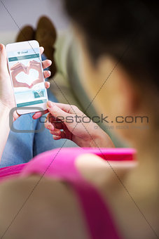 Composite image of woman using her smartphone