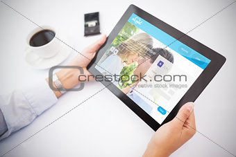 Composite image of man using tablet pc