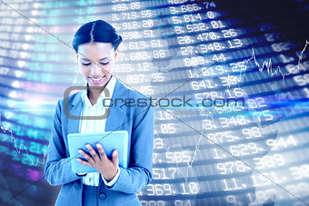Composite image of businesswoman using a tablet with colleagues behind