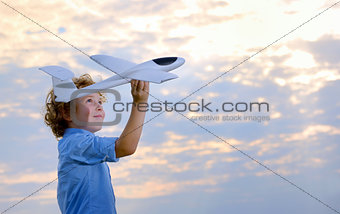 boy throwing airplane 