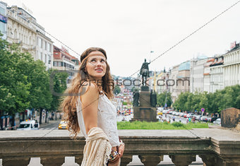 Happy bohemian woman tourist sightseeing in Prague