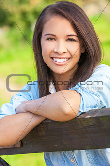 Beautiful Asian Eurasian Girl Resting on Fence
