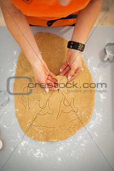 Woman making Halloween biscuits in kitchen. Closeup