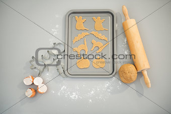 Uncooked Halloween biscuits on tray on table. Closeup