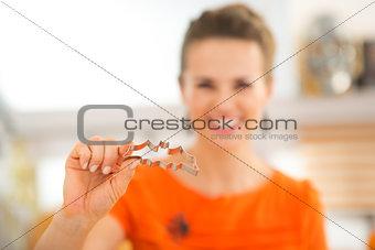 Closeup on woman holding cookie cutters for Halloween biscuits