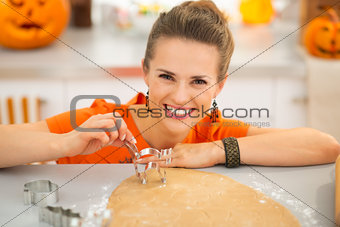 Housewife holding pastry cutter for Halloween biscuits