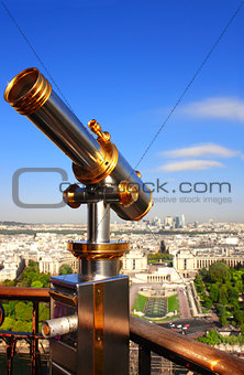 Telescope overlooking Paris up on Eiffel tower, France