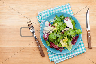 Plate with fresh salad, knife and fork. Diet food