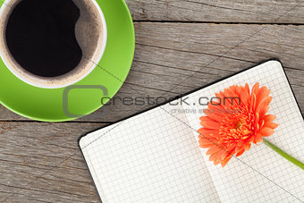 Blank notepad, coffee cup and orange gerbera flower