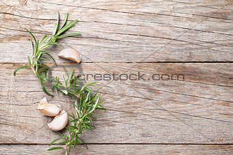 Rosemary and garlic on wooden table