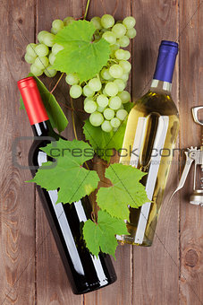 Bunch of grapes, wine bottles and corkscrew