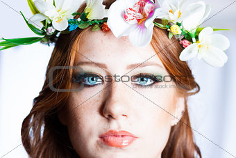 Beautiful long red hair girl with a flowers crown
