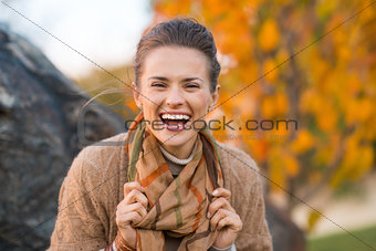Portrait of woman relaxing in beautiful evening autumn park
