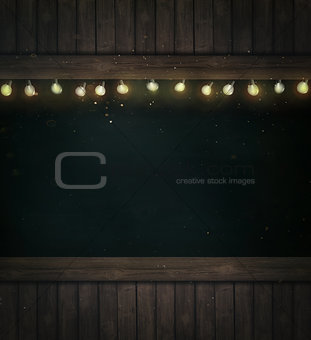 Christmas lights on wooden blackboard