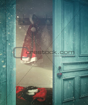 Rustic door opening into a room decorated for Christmas 