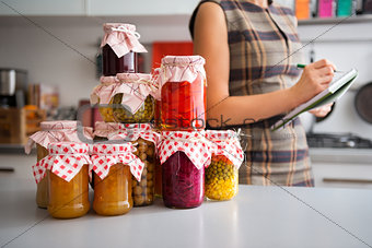 Closeup of preserved vegetables in glass jars on kitchen counter