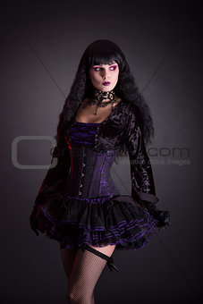 Halloween witch in purple costume 